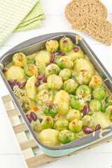 Brussels sprouts casserole with potatoes and kidney beans in cheese sauce