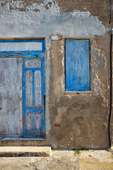 characteristic house with blue wooden doors and windows that are now old