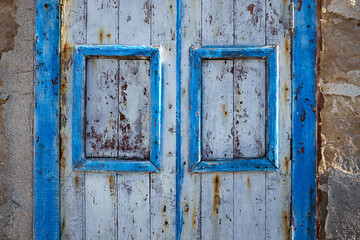 characteristic house with blue wooden doors and windows that are now old