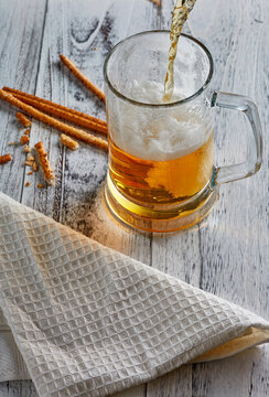 Close up view of beer pouring into glass mug. High quality photo