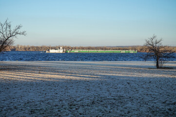 A loaded barge floats on a river in Europe 