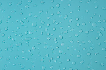 Liquid water drops on blue background, rain condensation flat lay, top view