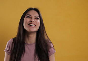 Young satisfied woman beams with happiness - studio photography