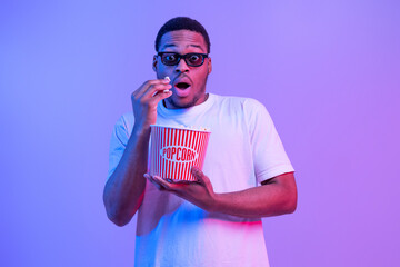 Portrait Of Shocked African American Guy In 3D Glasses Eating Popcorn