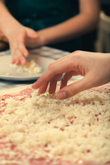 Obraz na płótnie Canvas Preparing pizza for baking in the oven.
