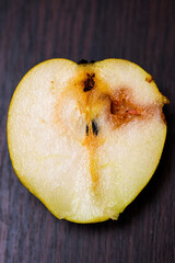 Caterpillar eating a apple . Worm (maggot larva) eating apple . Half of a wormy apple