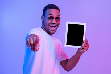 African Guy Holding Digital Tablet With Black Screen And Pointing At Camera