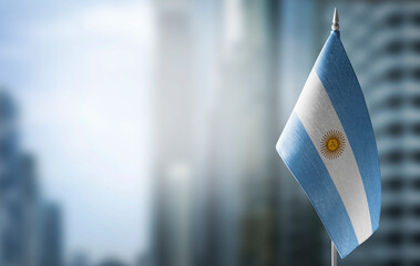 A small flag of Argentina on the background of a blurred background