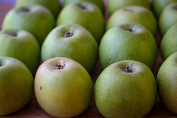 Apples stand on a wooden surface