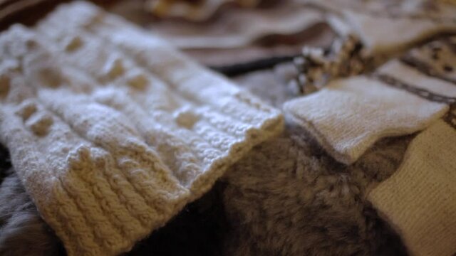 Detailed videography of soft wool scarves, dress and several caps of various shades, with neat designs, using alpacas fleece as raw material. 