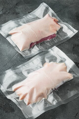 Duck breast, raw freshly slaughtered by the bio farm prepared for vacuuming and smoking, on gray stone background