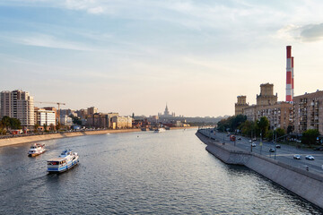 Sunset Moscow river, ships and city buildings