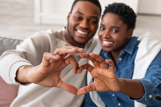 Portrait Of African American Couple Making Heart Shape With Hands