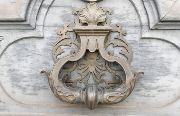 European Vintage old metal wrought iron door knocker. Design detail. Paris.