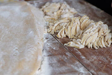 Piles of freshly cut egg noodles on a pile