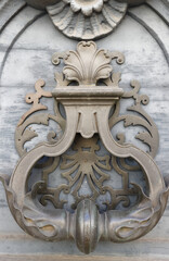 European Vintage old metal wrought iron door knocker. Design detail. Paris.