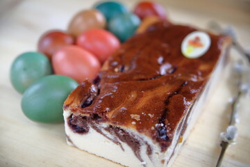 cheesecake  with chocolate and painted easter eggs close up