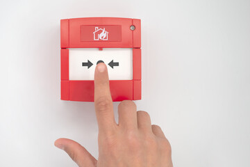 Hand presses fire alarm button - 425384162
