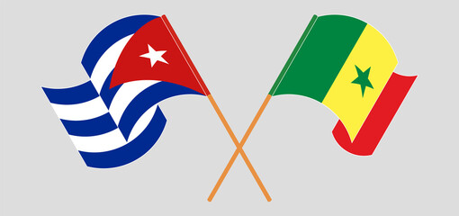 Crossed and waving flags of Cuba and Senegal