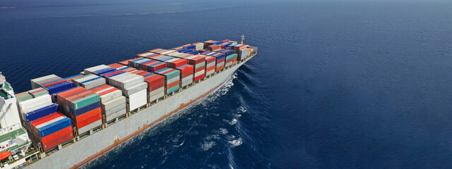 Aerial drone panoramic ultra wide photo of industrial container tanker ship cruising in open ocean...