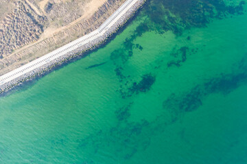 Seashore with turquoise water. Conceptual photo - sea and coast. Helicopter view.