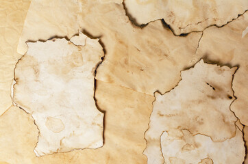 Fototapeta premium background made of pieces of old brown paper slightly burned on the edges