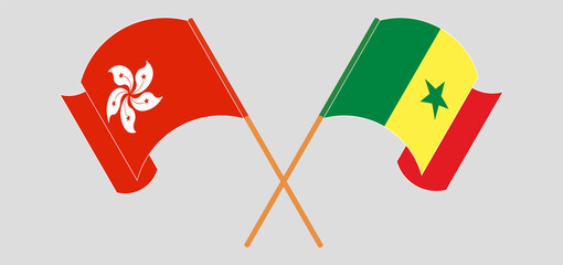 Crossed and waving flags of Hong Kong and Senegal