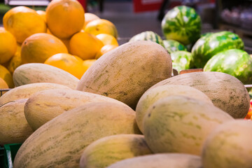 Melons are lying in a pile for sale