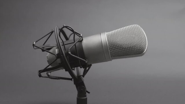 Professional studio microphone on an anti vibration stand, being side lit