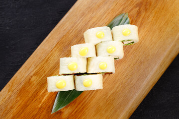 Fototapeta na wymiar Sushi rolls with vegetables and tofu, vegan food