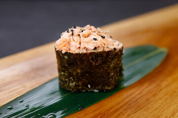 Gunkan maki sushi roll on wooden platter