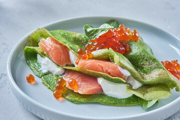 Green spinach crepes with smoked salmon
