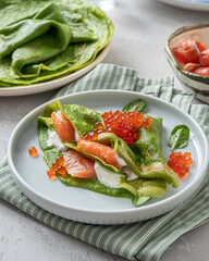 Green spinach crepes with smoked salmon