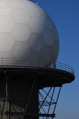 a giant dome radar clos up on the top of a high hill