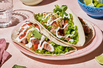 Tacos with grilled chicken, avocado, fresh salsa sauce and limes