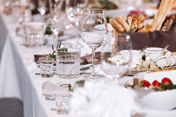 Flower table decorations for holidays and wedding dinner. Table set for holiday, event, party or wedding reception in a restaurant.
