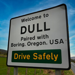 Dull paired with Boring road sign in Perthshire, Scotland. Vibrant, colourful background of blue sky and green countryside.