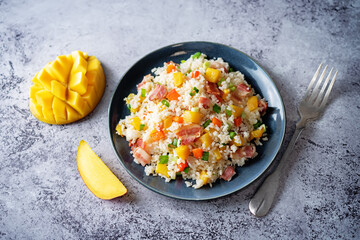 Fried bacon mango Red bell pepper rice in a plate