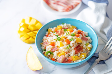 Fried bacon mango Red bell pepper rice in a plate
