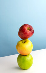 Balancing fruit, creative concept. Three colorfull apples