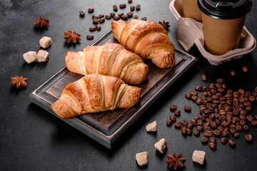 Fresh crisp delicious French croissant with a cup of fragrant coffee