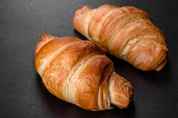 Fresh crisp delicious French croissant with a cup of fragrant coffee