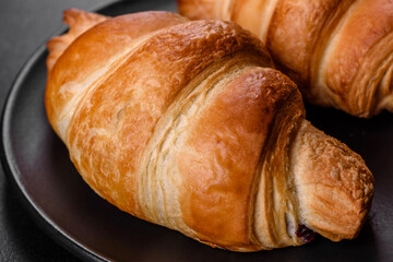 Fresh crisp delicious French croissant with a cup of fragrant coffee