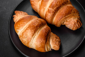Fresh crisp delicious French croissant with a cup of fragrant coffee