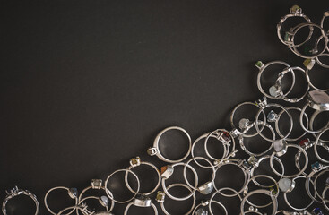 A set of silver rings on a dark background.Handmade jewelry. Space for the text.