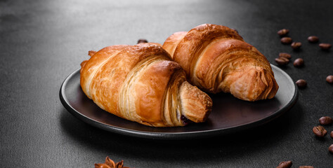 Fresh crisp delicious French croissant with a cup of fragrant coffee
