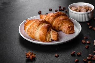 Fresh crisp delicious French croissant with a cup of fragrant coffee