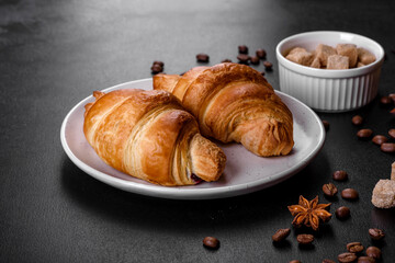 Fresh crisp delicious French croissant with a cup of fragrant coffee