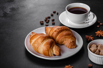 Fresh crisp delicious French croissant with a cup of fragrant coffee