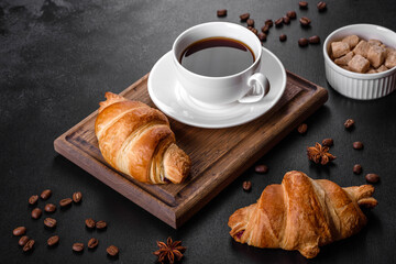 Fresh crisp delicious French croissant with a cup of fragrant coffee